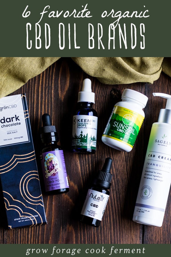six different cbd oil products on a wooden table